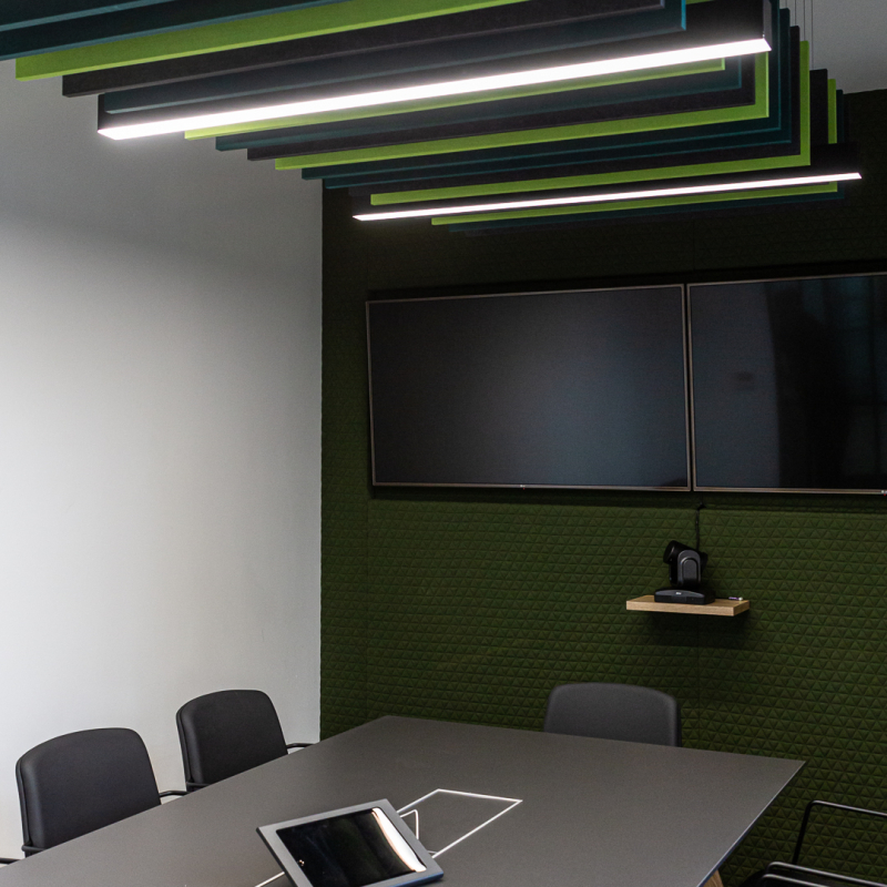 boardroom with 8 person meeting table and chairs with AV screen and VC  also with acoustic panels