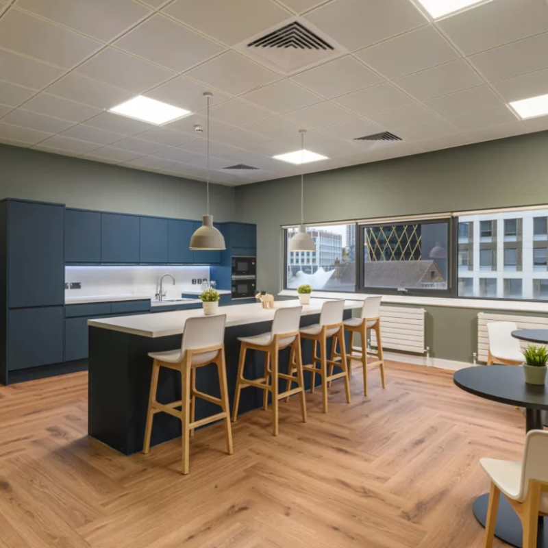 walking through into the suite seeing central Island with seating and kitchen tea point