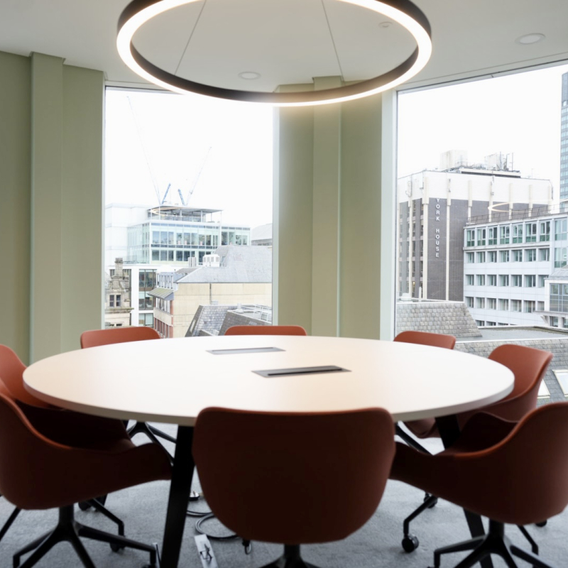 turret meeting room with 8 person circular meeting table with CBD outlook of Manchester from the room