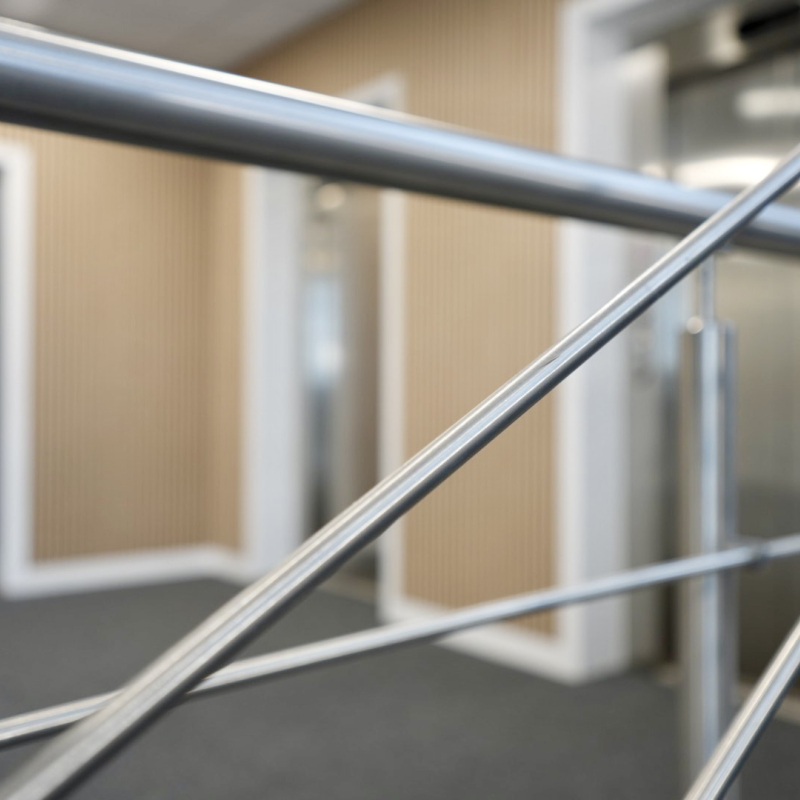 common area of landing spaces new wooden slatted panelling, refurbished lift fronts and surrounds and stairs hand rail and new flooring