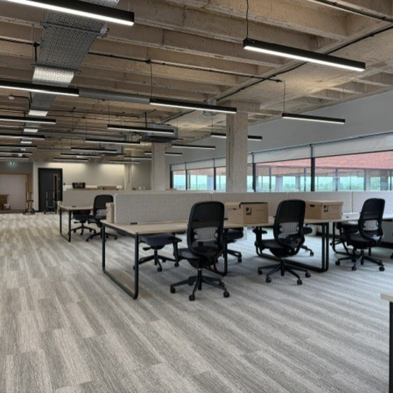 office of open plan with desks chairs and interface flooring