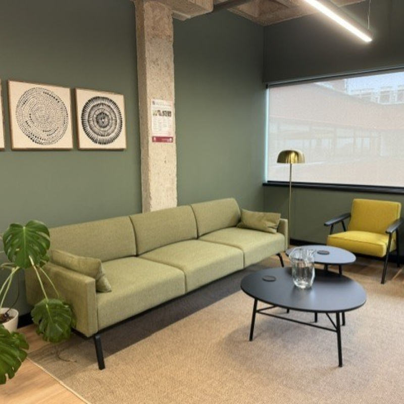reception waiting area seating with chairs and sofa with planting