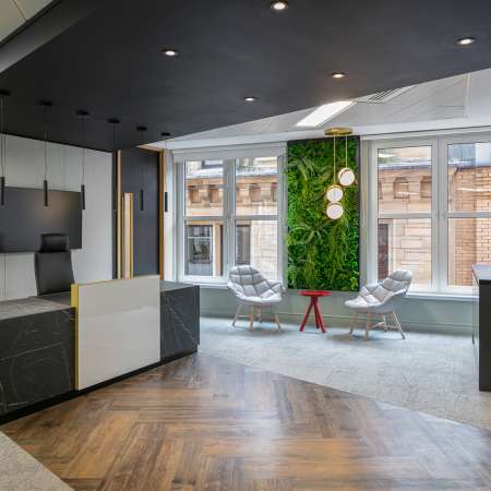reception entrance with desk and waiting area with green wall